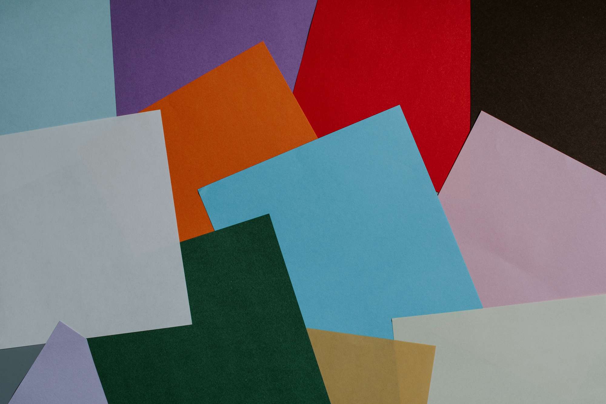 Top down photo of colored papper rectangles pseudo-chaotically laid out to be equal parts interesting and pleasing