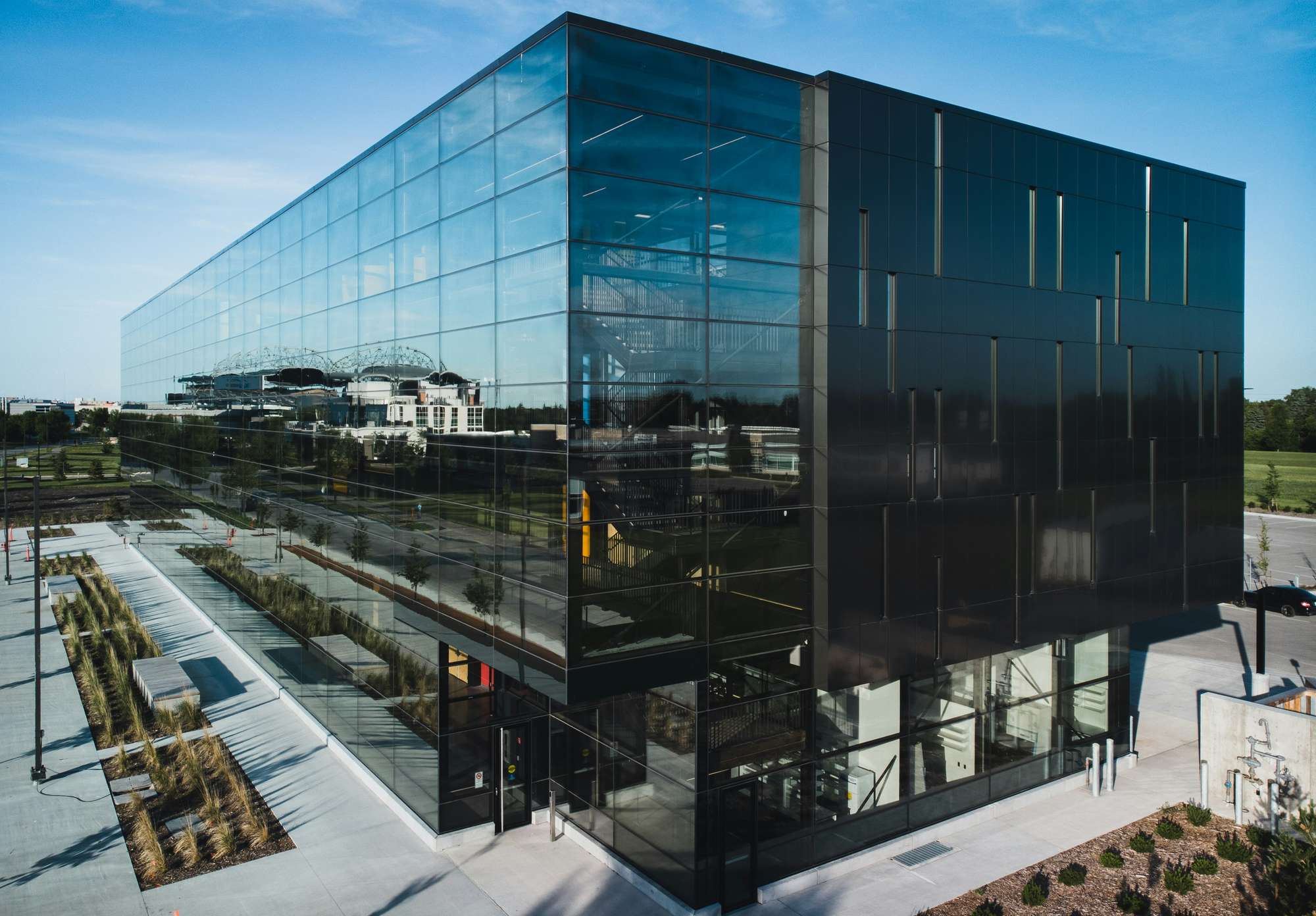 Moody photo of a dark and modern geothermal building within Smartpark at the University of Manitoba