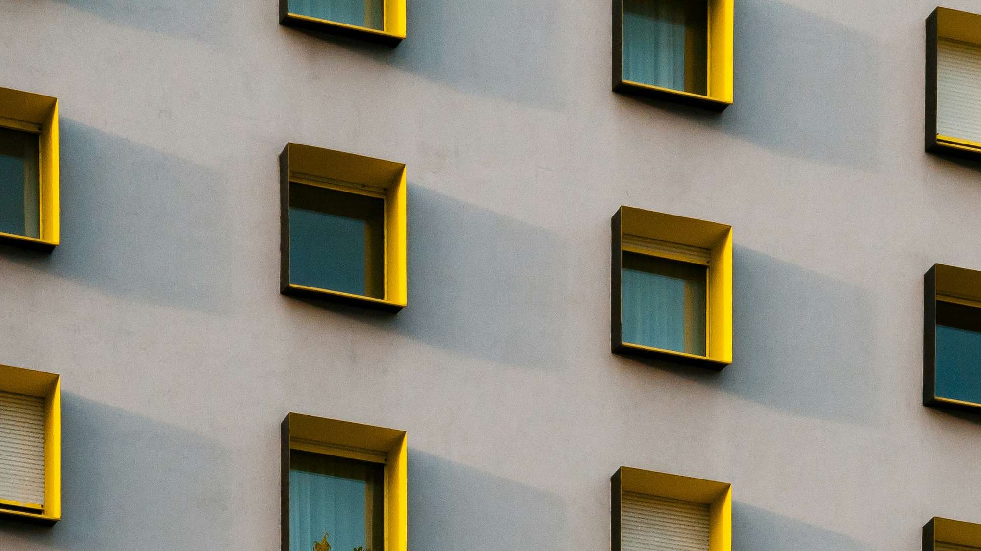 A residential building with mutliple rows of identical windows