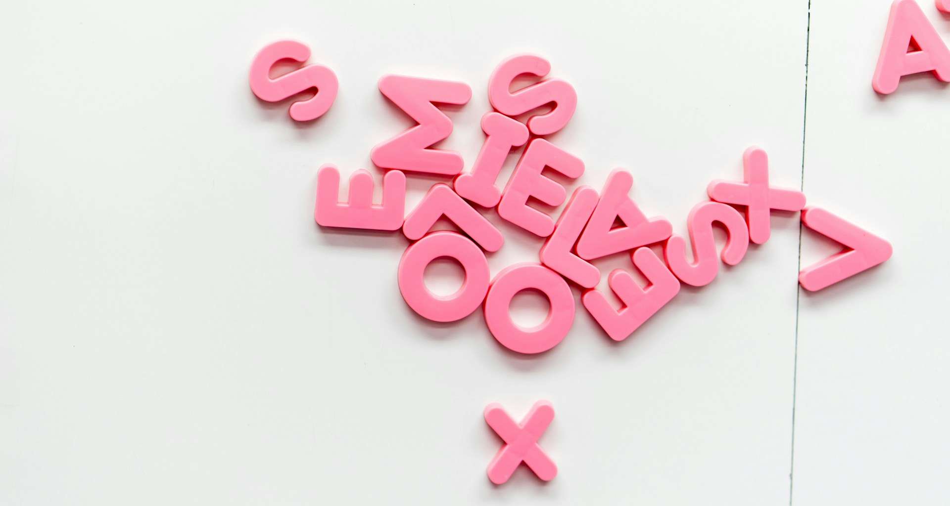 A small collection of magnetic letters as are often used for fridges or kids white boards
