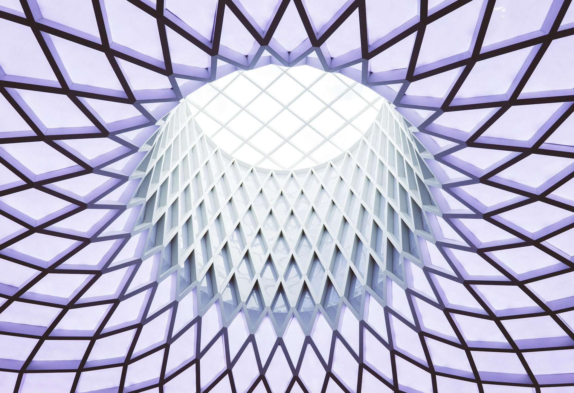 Photo of a regularly-structured ceiling with a circular opening in the center