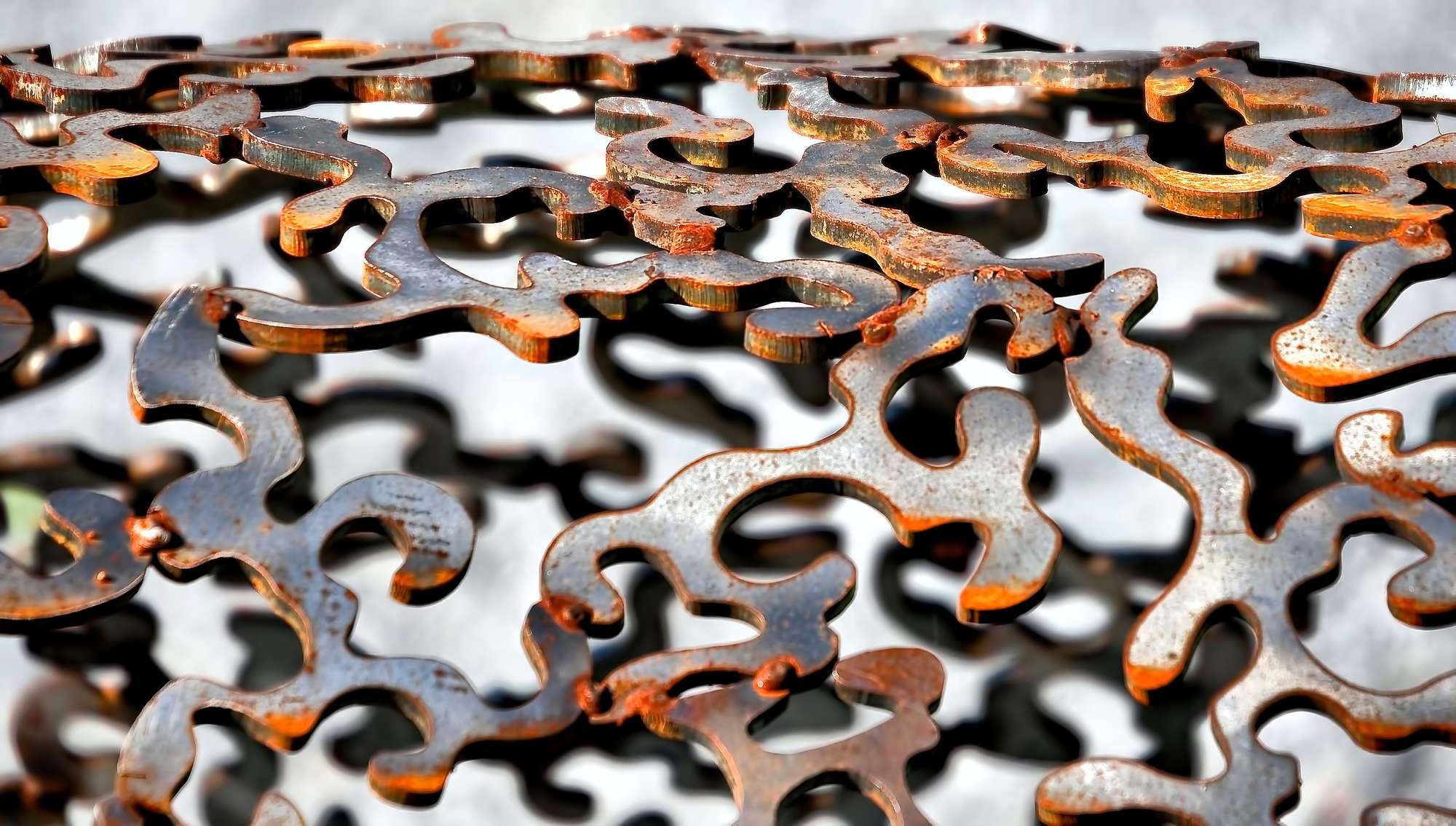Close-up of a sculpture consisting of abstract metal pieces, which are partially rusted.