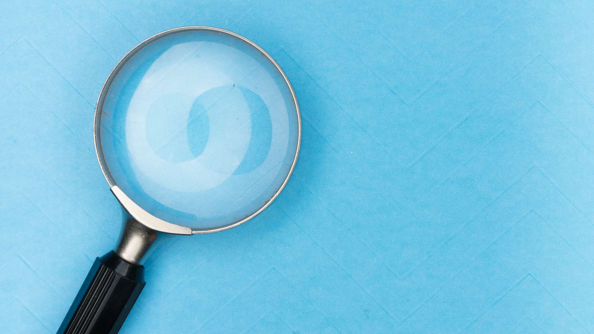 A magnifying glass on a blue background